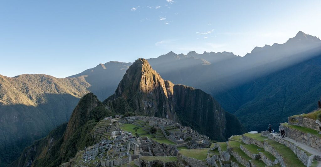 Dramatic aerial view of Machu Picchu with sunrays, capturing its ancient beauty and mountainous landscape.