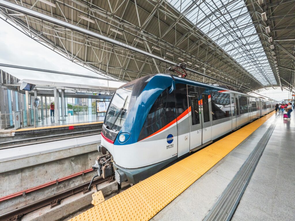 Modern metro train at San Miguelito station in Panama City, showcasing urban public transportation.