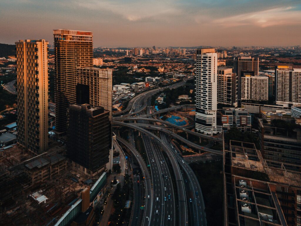 Stunning aerial shot of Petaling Jaya's cityscape at dusk, showcasing its roads and skyscrapers.