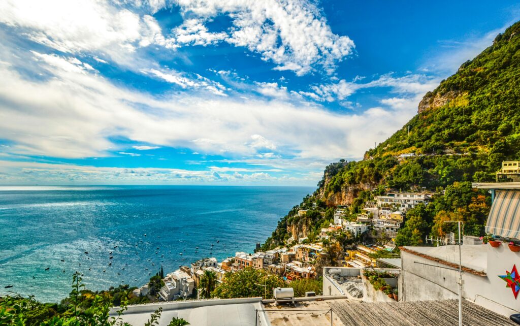 Breathtaking view of the Amalfi Coast with vibrant blue sea and lush green hillsides.