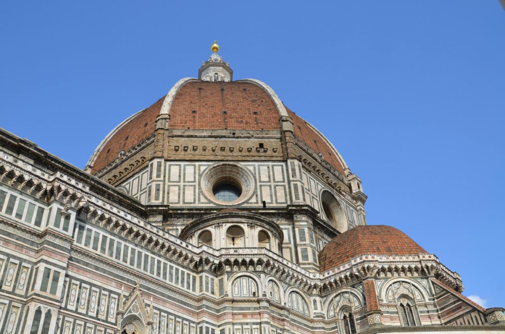 Stunning view of the Florence Cathedral dome showcasing Renaissance architecture under a clear blue sky.