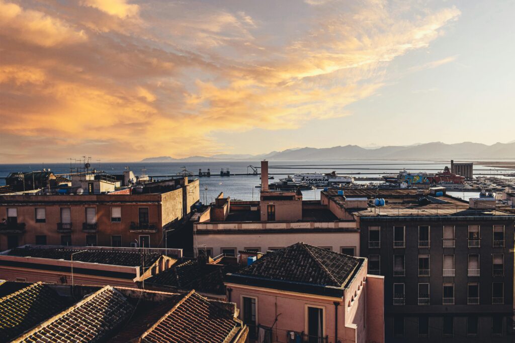 Breathtaking sunset over Cagliari, Sardinia with a view of urban architecture and the Mediterranean Sea.
