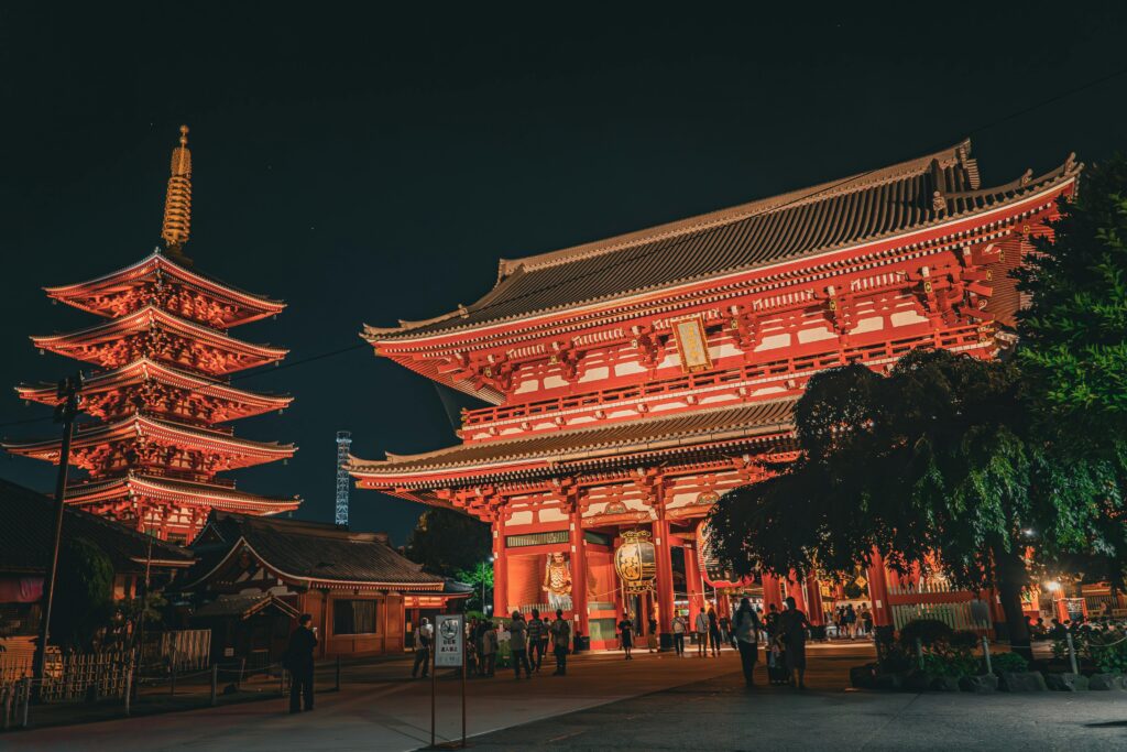 Illuminated Senso-ji Temple in Tokyo at night, showcasing traditional Japanese architecture.