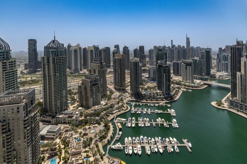 Stunning aerial view of Dubai Marina's skyline and waterfront, showcasing modern architecture and luxury yachts.