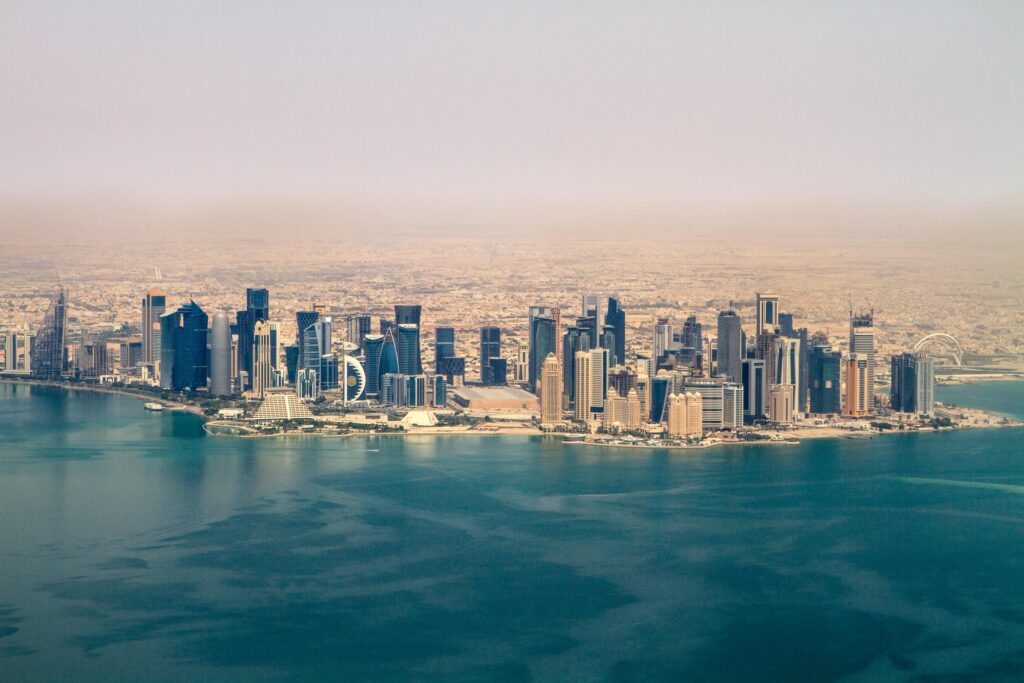 Stunning aerial view of the Doha skyline under a clear sky, showcasing modern architecture in Qatar.