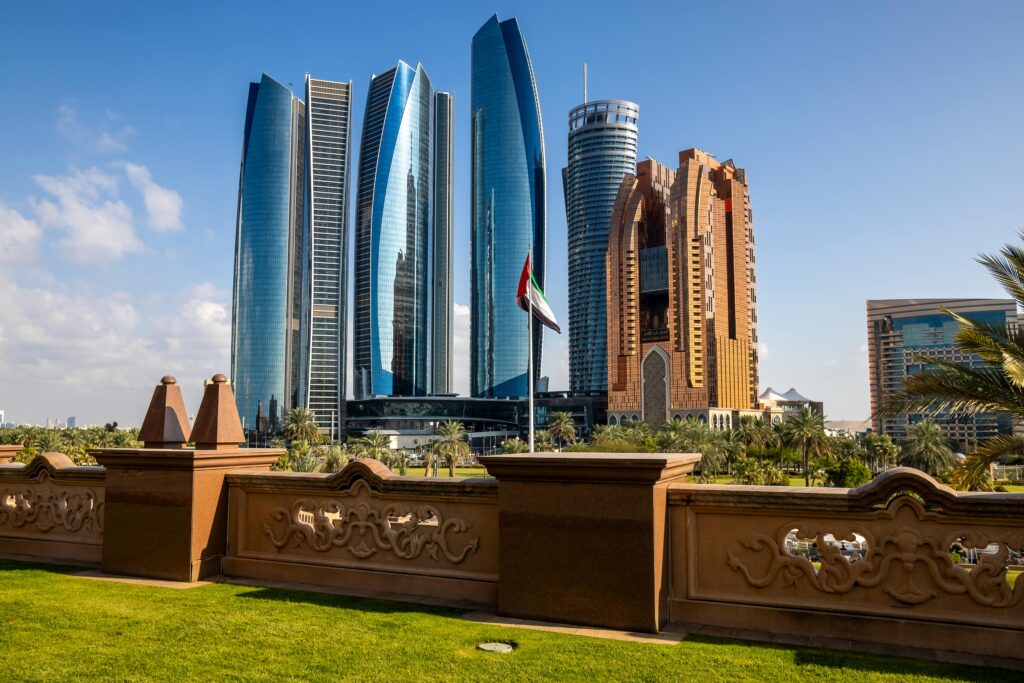 Stunning view of Abu Dhabi's Etihad Towers and city skyline under clear blue sky.