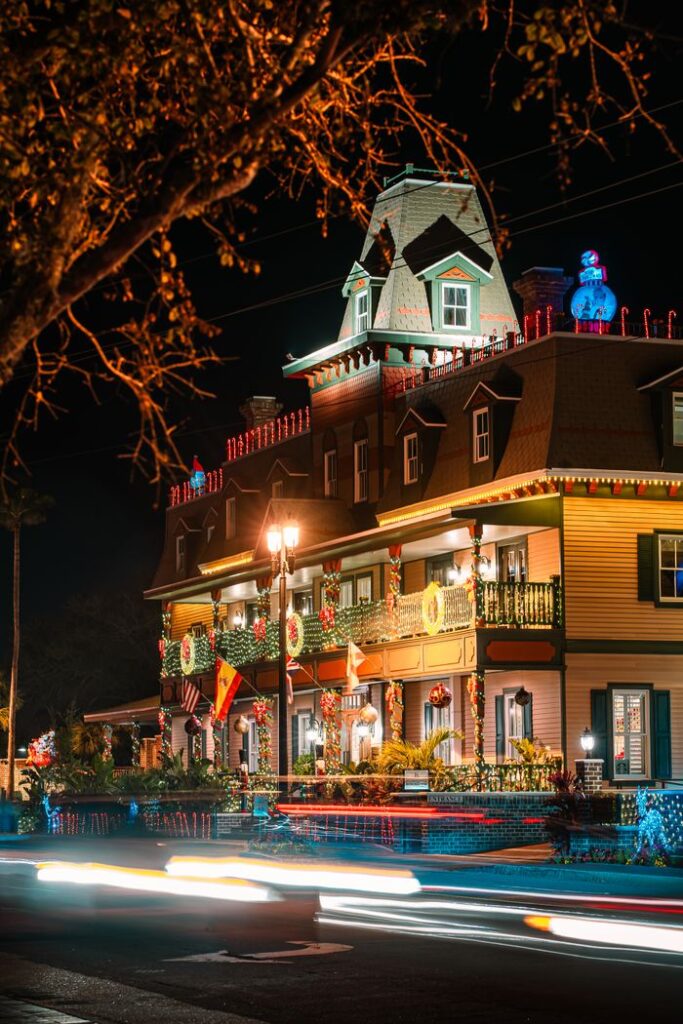 Explore vibrant Christmas lights illuminating a historic building in St. Augustine at night.